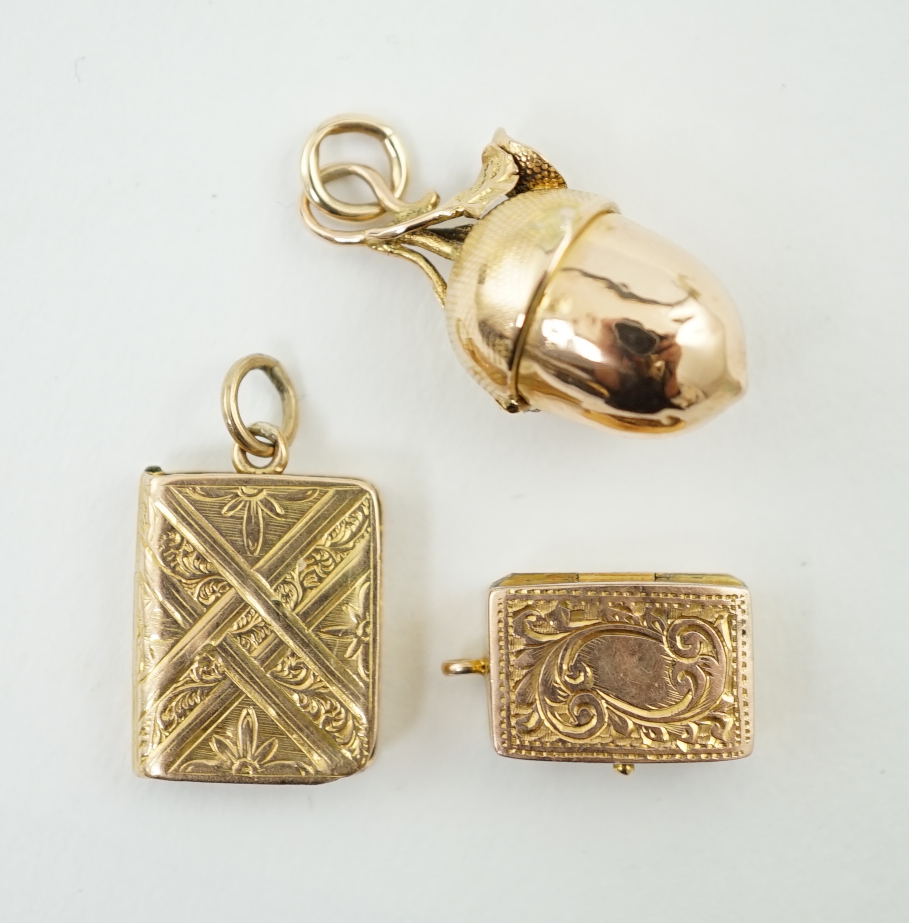 Three small gold vinaigrette charms